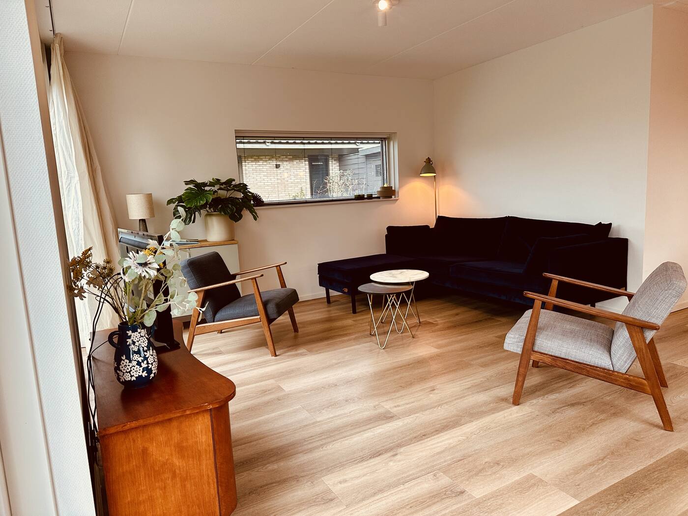 Woonkamer met zithoek en grote ramen